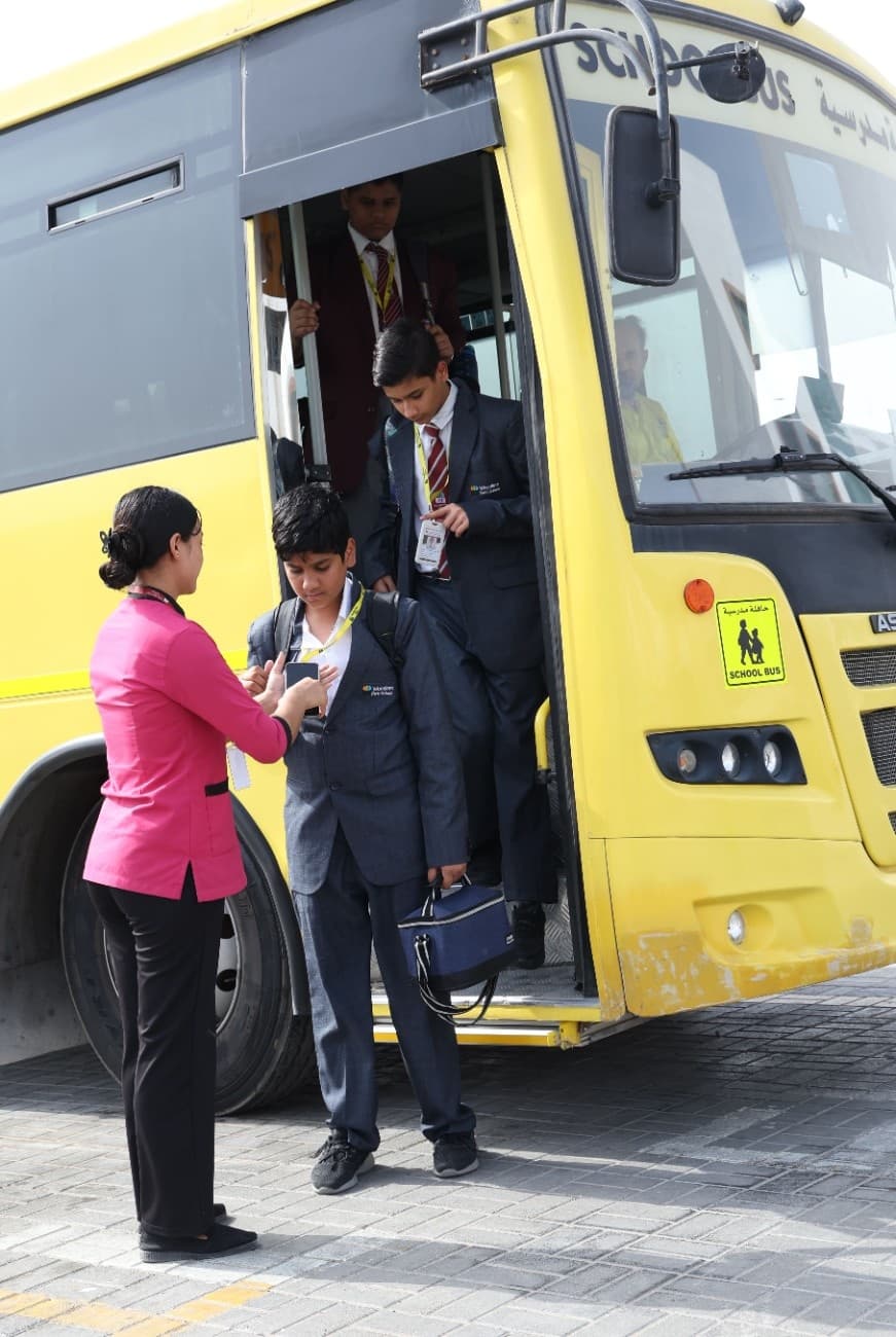 Students utilizing the smart punch-out terminals while leaving the school bus