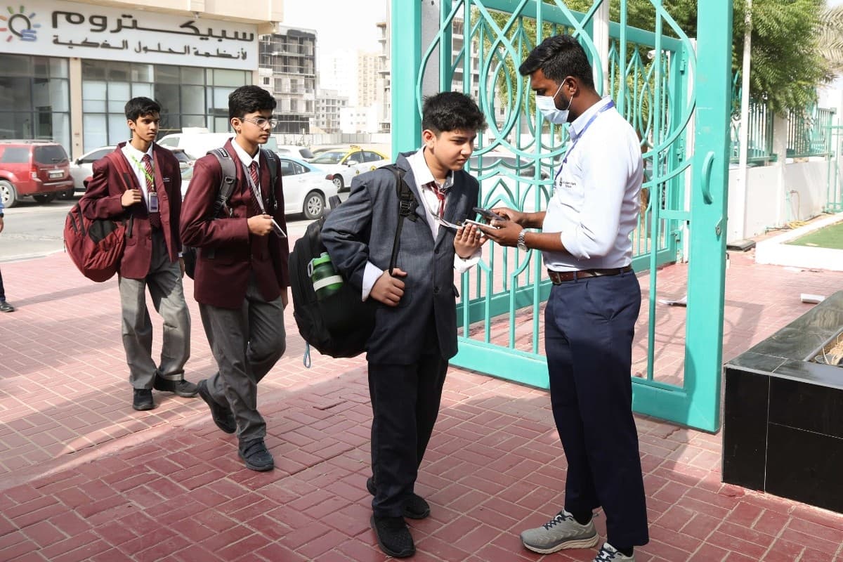 Students using attendance tracking terminals upon entering the school building